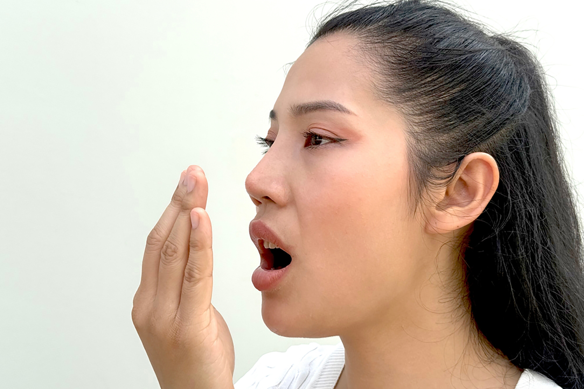 Women have bad breath due to swollen and inflamed gums.